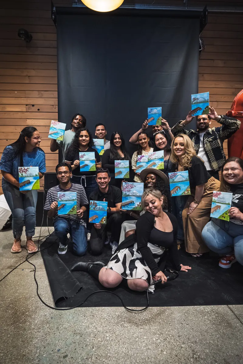 The whole group holding up their finished lake paintings